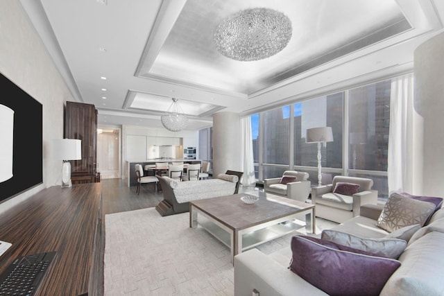 living room featuring a raised ceiling and wood finished floors