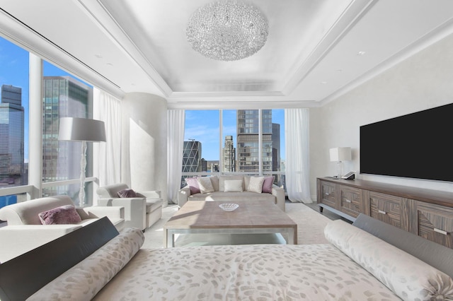 living room with floor to ceiling windows and a raised ceiling