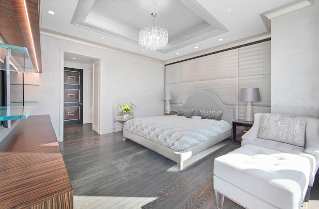 bedroom featuring a raised ceiling, wood finished floors, recessed lighting, baseboards, and a chandelier