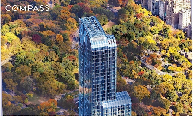 drone / aerial view featuring a view of city and a view of trees