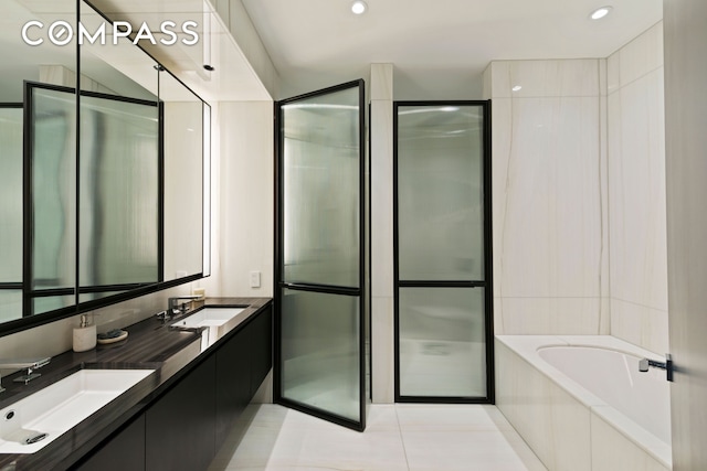 bathroom with tile patterned flooring, a garden tub, recessed lighting, and a sink