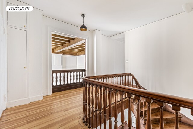 hall featuring crown molding and an inviting chandelier