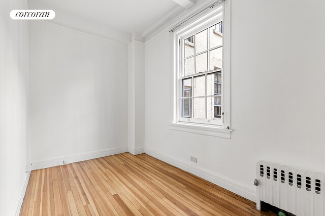 131 E 66th St Unit 8/9C, New York City, NY 10065 - living room with a high ceiling, a premium fireplace, coffered ceiling, and light wood-type flooring