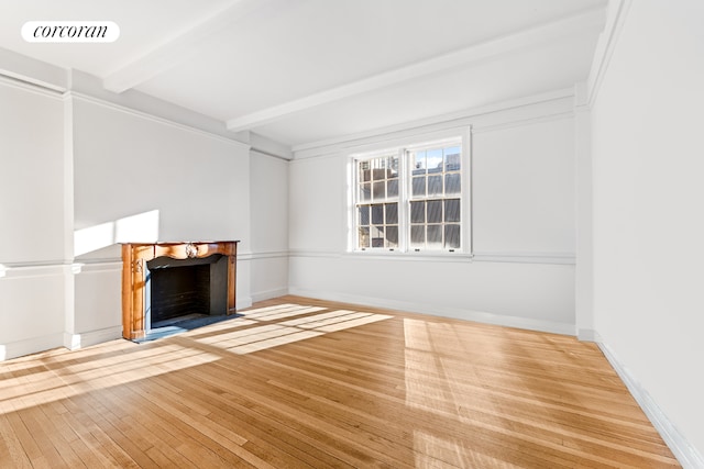 living room featuring coffered ceiling, a towering ceiling, beam ceiling, and light hardwood / wood-style floors