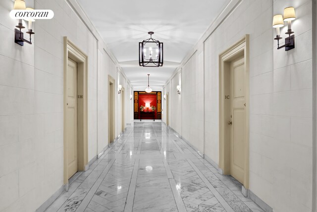 stairway with an inviting chandelier and a textured ceiling