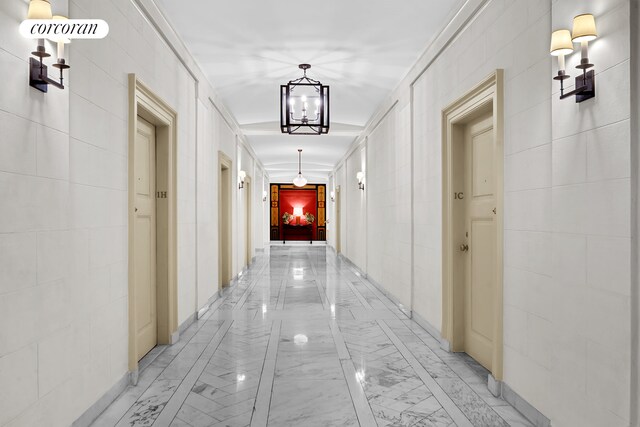 131 E 66th St Unit 8/9C, New York City, NY 10065 - stairway with an inviting chandelier and a textured ceiling