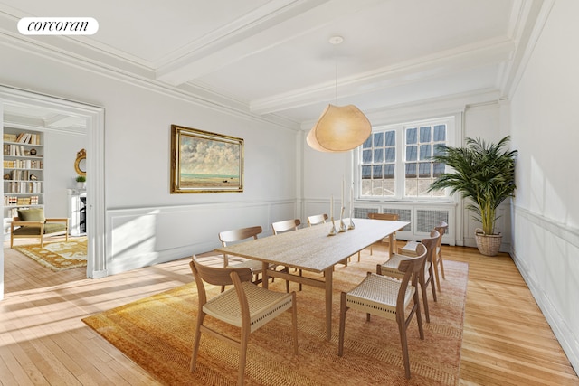 dining space featuring built in shelves, light hardwood / wood-style flooring, crown molding, and beamed ceiling