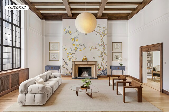 131 E 66th St Unit 8/9C, New York City, NY 10065 - unfurnished living room with a premium fireplace, light hardwood / wood-style floors, beam ceiling, and built in shelves