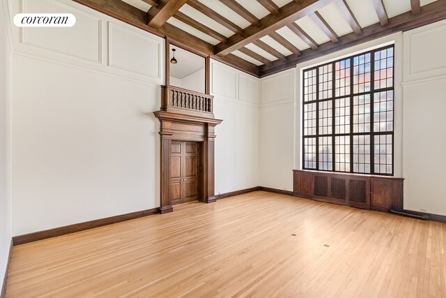 131 E 66th St Unit 8/9C, New York City, NY 10065 - living room featuring crown molding, light hardwood / wood-style floors, beam ceiling, and built in shelves