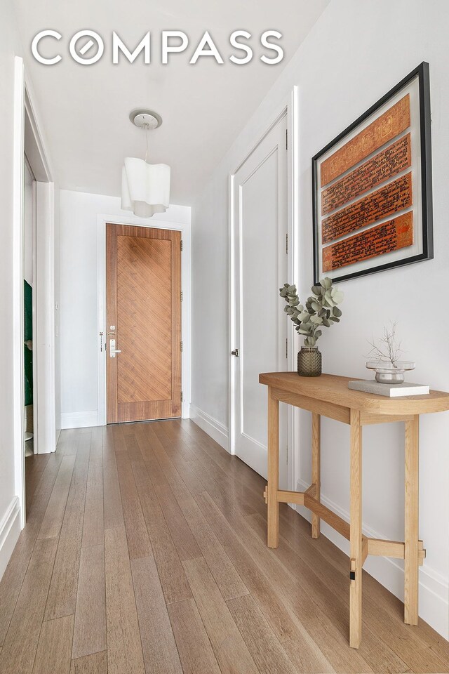 corridor featuring hardwood / wood-style floors