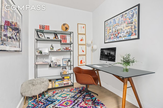 office area featuring baseboards and wood finished floors