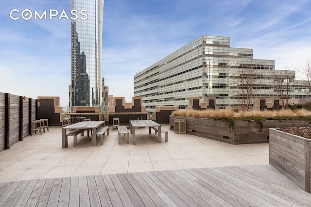 exterior space featuring outdoor dining area, a city view, and a patio area