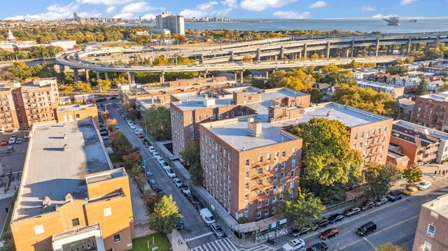 birds eye view of property with a water view and a city view