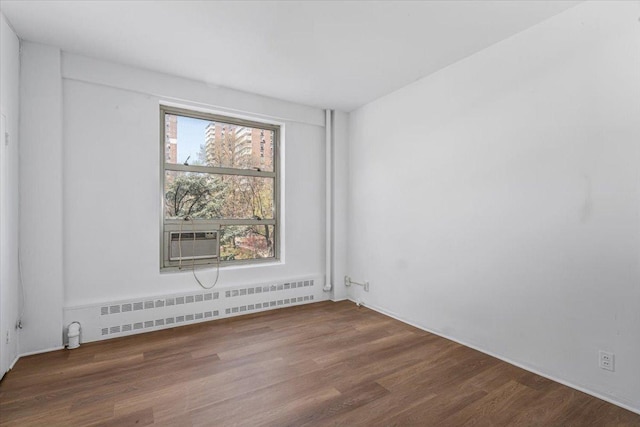 501 W 123rd St Unit 3A, New York City, NY 10027 - unfurnished room featuring baseboard heating, wood finished floors, cooling unit, and radiator heating unit