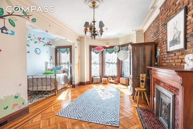 sitting room featuring a fireplace, radiator heating unit, an inviting chandelier, and crown molding