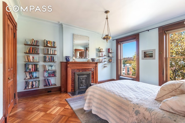 bedroom with multiple windows, a fireplace, baseboards, and ornamental molding