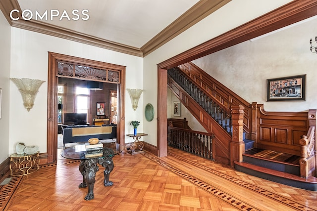 interior space with stairway, baseboards, and ornamental molding