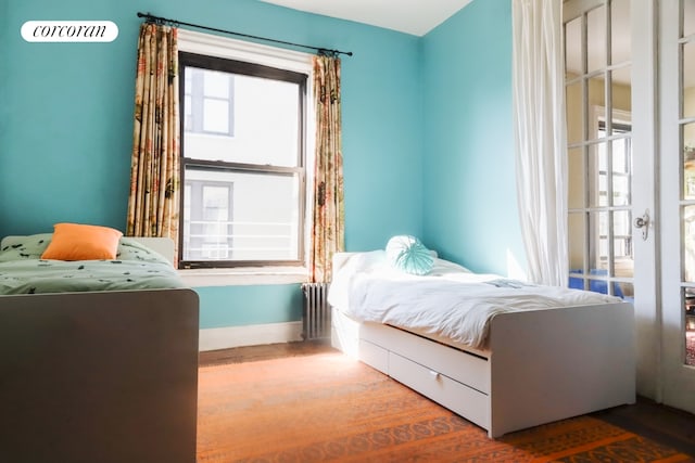 bedroom featuring radiator heating unit and baseboards