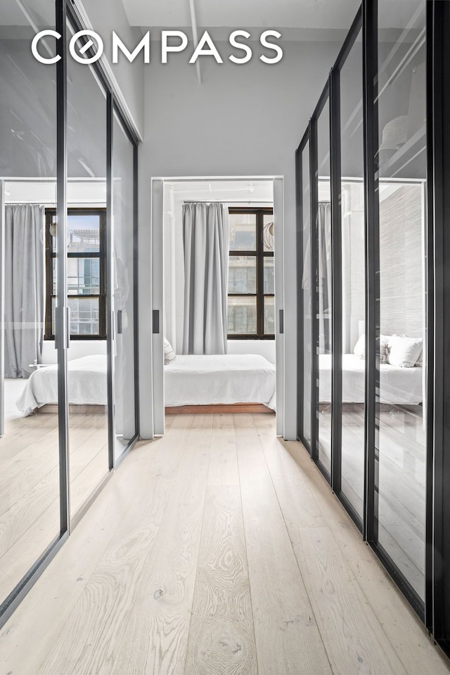 hall featuring hardwood / wood-style floors and a high ceiling