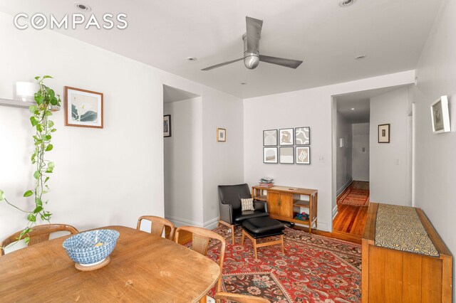 dining space featuring ceiling fan, wood finished floors, and baseboards