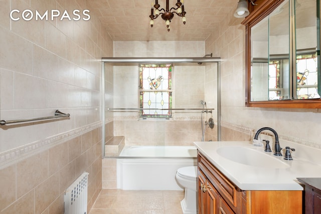 bathroom featuring radiator, tile walls, and vanity