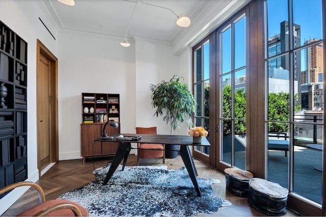 office area featuring plenty of natural light, ornamental molding, and dark parquet flooring