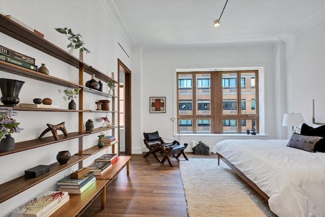 bedroom featuring crown molding and dark hardwood / wood-style floors