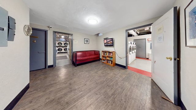 interior space with dark wood-type flooring and baseboards