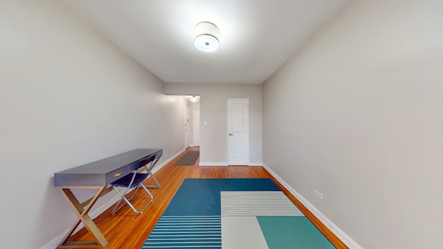 doorway to outside with wood finished floors and baseboards