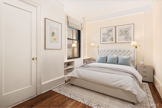 bedroom featuring ornamental molding and wood-type flooring