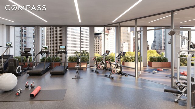 workout area featuring floor to ceiling windows and a city view