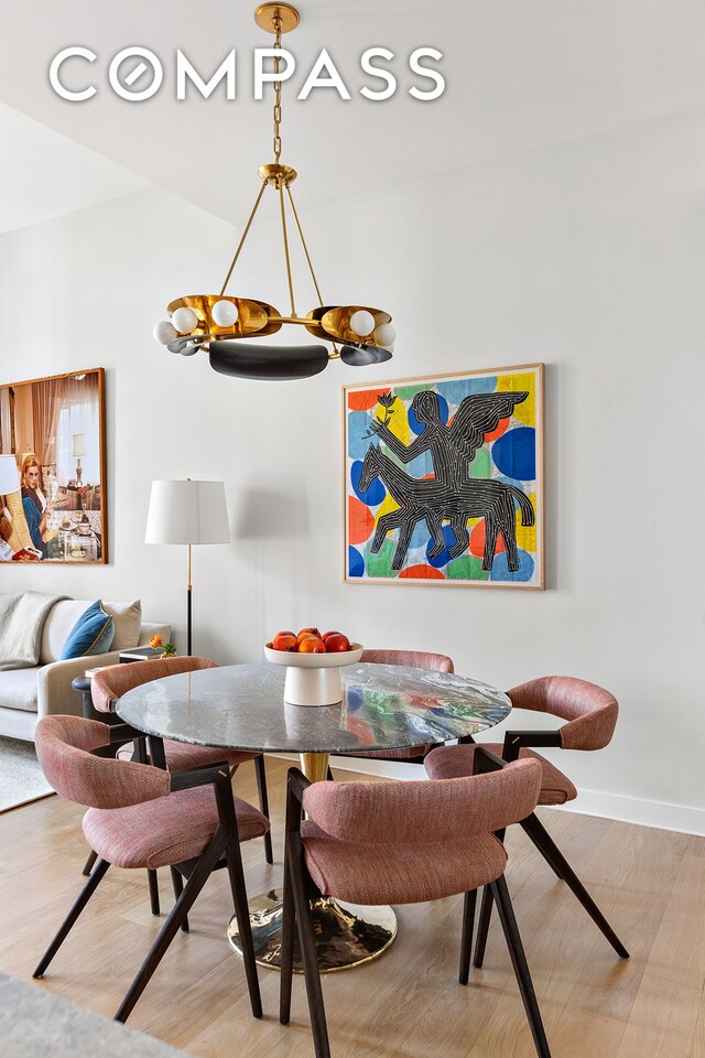 dining room featuring baseboards and wood finished floors