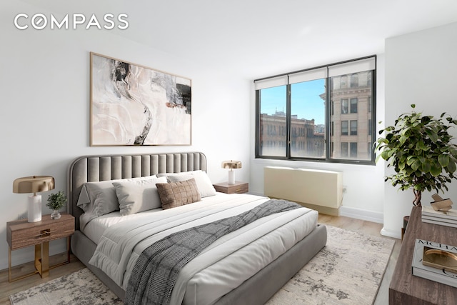 bedroom with baseboards and wood finished floors