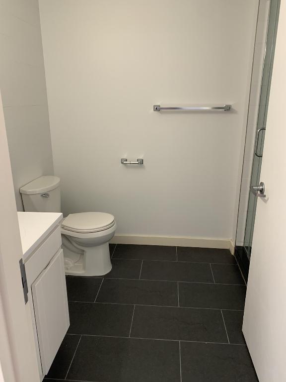 bathroom featuring toilet, vanity, and tile patterned flooring