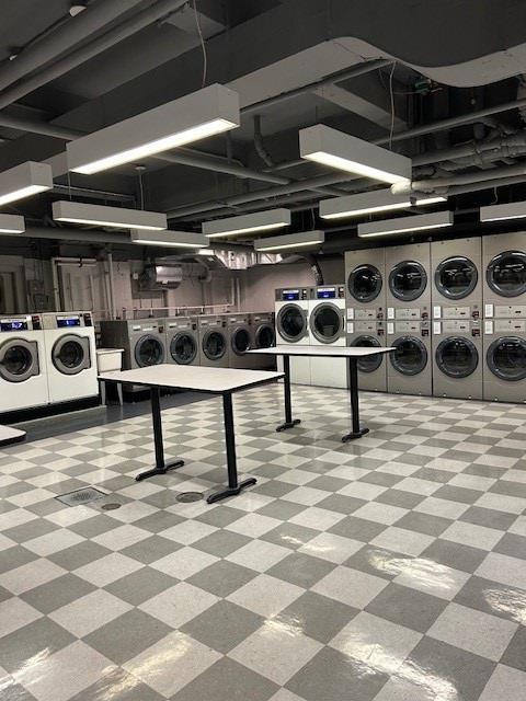 220 Madison Ave Unit 15N, New York City, NY 10016 - common laundry area with tile patterned floors, stacked washer / dryer, and separate washer and dryer