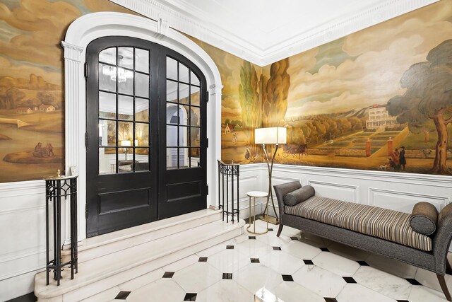 220 Madison Ave Unit 15N, New York City, NY 10016 - tiled foyer featuring wainscoting, arched walkways, and a decorative wall