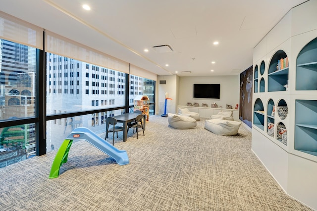 interior space with visible vents, recessed lighting, built in shelves, and carpet floors