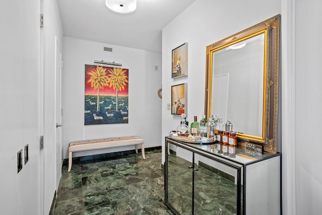 721 5th Ave Unit 33G, New York City, NY 10022 - hallway featuring marble look tiles and baseboards
