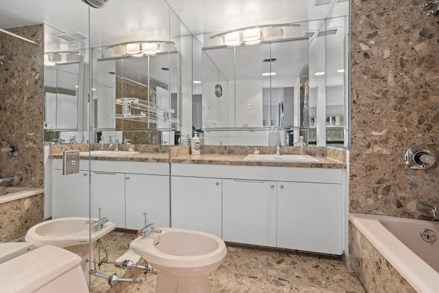 721 5th Ave Unit 33G, New York City, NY 10022 - bathroom featuring a bidet, double vanity, stone finish floors, and tiled shower / bath combo