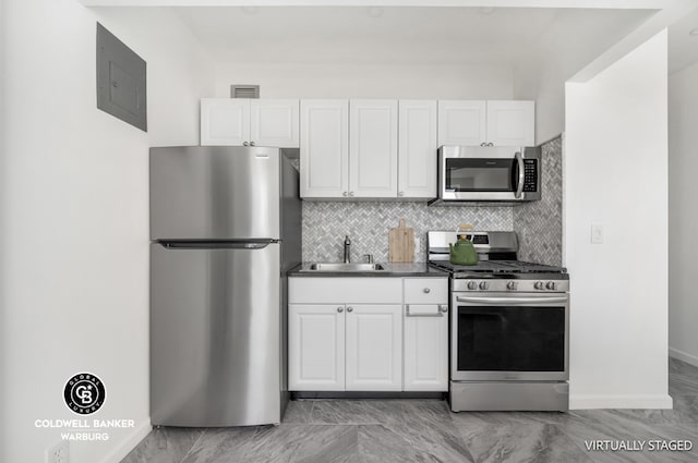 kitchen with sink, white cabinetry, and stainless steel appliances