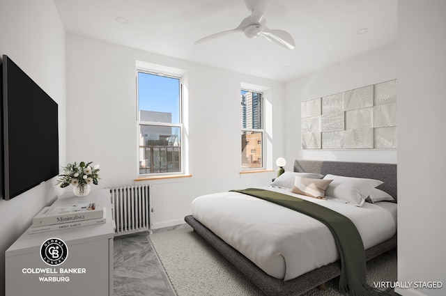 bedroom with ceiling fan and radiator