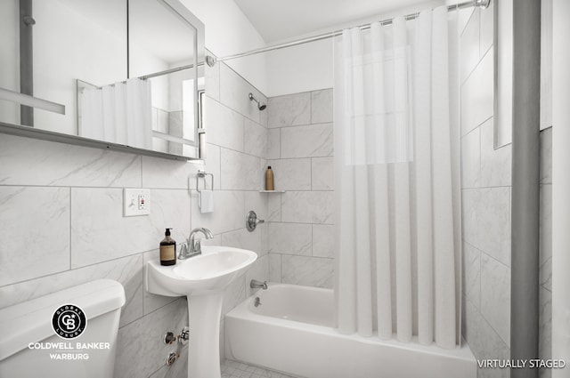 full bathroom with shower / tub combo, tile walls, sink, tasteful backsplash, and toilet