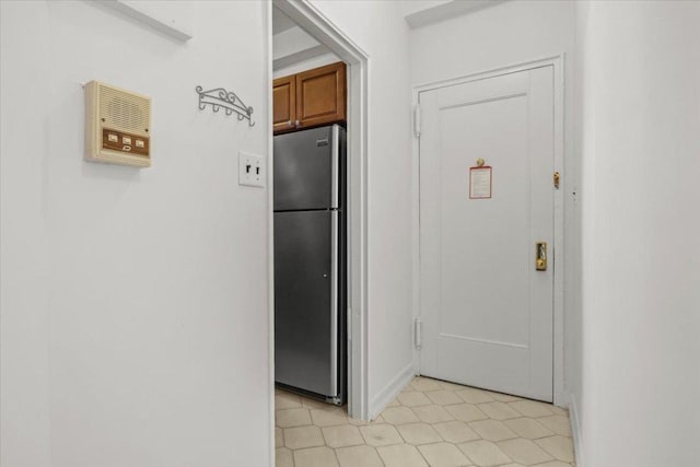 kitchen featuring brown cabinets and freestanding refrigerator