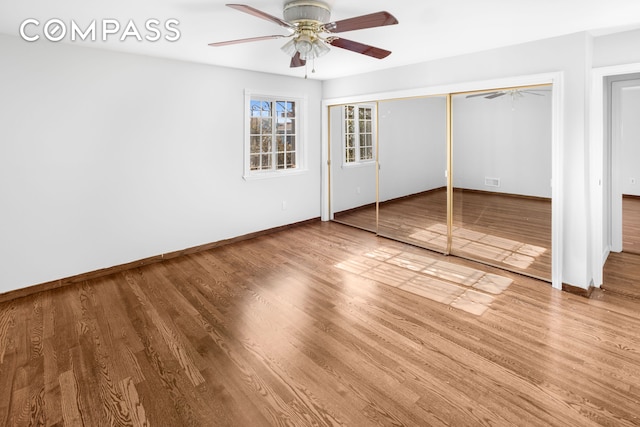 unfurnished bedroom featuring visible vents, baseboards, and wood finished floors