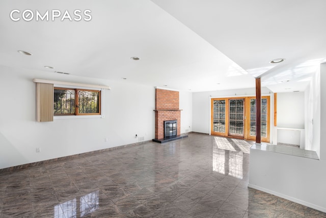 unfurnished living room with visible vents, a fireplace, baseboards, and recessed lighting