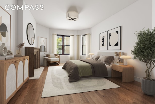 bedroom featuring baseboards and wood finished floors