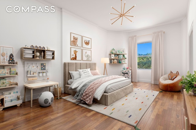 bedroom featuring crown molding, a chandelier, and wood finished floors