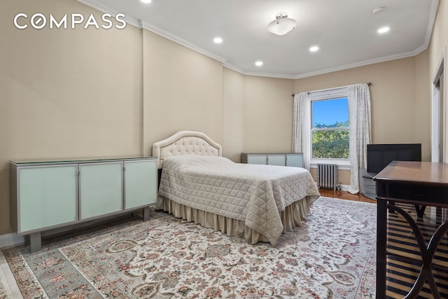 bedroom with baseboards, radiator heating unit, wood finished floors, crown molding, and recessed lighting