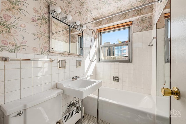 bathroom with toilet, tile walls, and tile patterned flooring