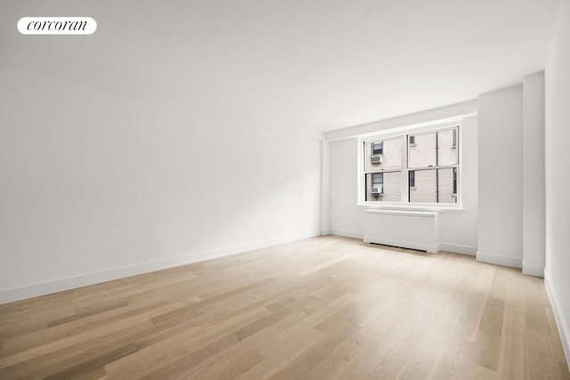 55 E 87th St Unit 14E, New York City, NY 10128 - spare room featuring light wood-style floors and baseboards